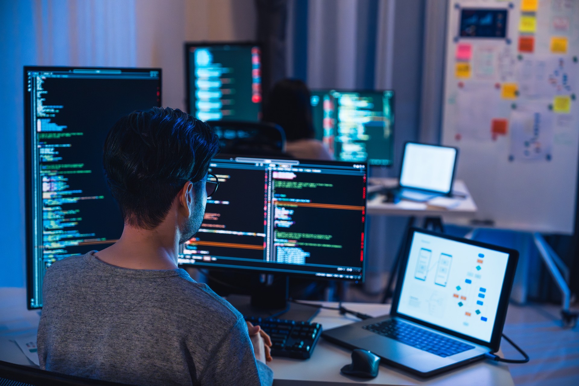 asian and Indian Developer  devops team working  about coding promgram with software computer at night in office